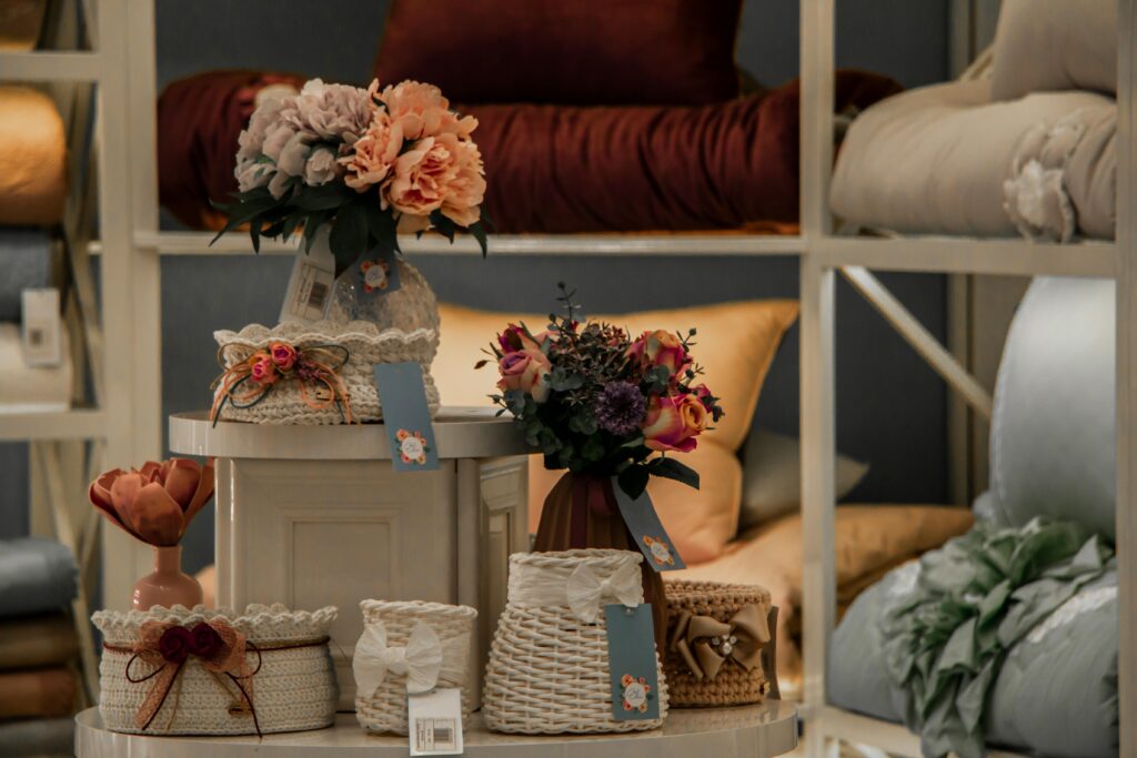 A cozy indoor setting featuring wicker baskets adorned with colorful floral arrangements.